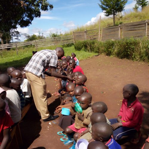 JDI staff giving deworming Tablets and Vitamin A suppliments to students in Bethel Primary School in Zeu Sub County.