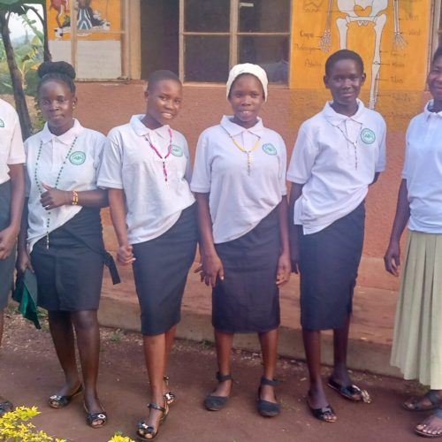 The dropout school girls being trained by JDI on tailoring and garment cutting poss for photo.