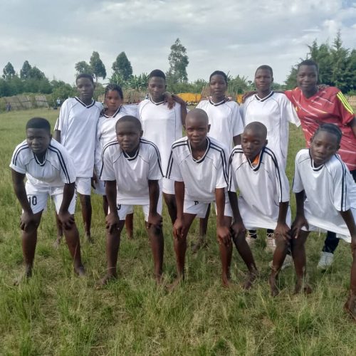 girls under 12 posing for team photo before their game